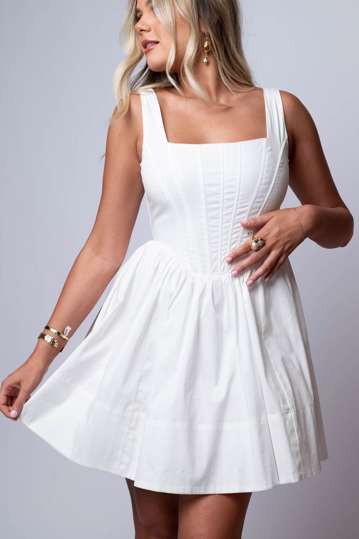 the Celeste Corset Dress features a flattering square neckline, boning on the bodice for structure, and a back zipper for a seamless look. The gathered and flounce skirt creates an A-line silhouette, perfect for any occasion. In a beautiful ivory shade. Hand Wash 100% Polyester Import Fit Guide: Isabella is 5ft 6 inches Bust 34”, Waist 26”, Hips 35” Model is wearing a small True to size *Available at our Envy location Fitted A-line Sundress Corset Dress, Summer Mini Dress With Square Neck And Lined Bodice, Fitted Bodice Mini Dress With Ruffles And Square Neck, Spring Corset Dress With Boned Bodice And Square Neck, Chic Mini Dress With Ruched Bodice And Square Neck, Square Neck Mini Dress With Ruffled Fitted Bodice, Mini Dress With Ruffles, Fitted Bodice, And Straight Neckline, Mini Dress With Ruffles And Fitted Bodice Straight Neckline, Fitted Square Neck Daywear Dress