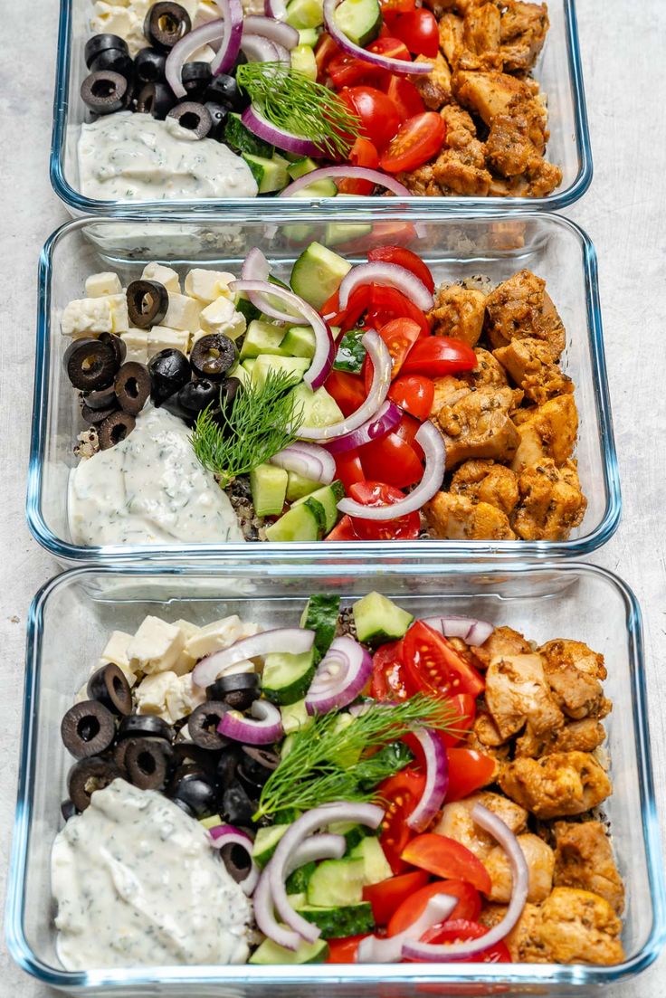 three plastic containers filled with different types of salads and dressing on top of each other