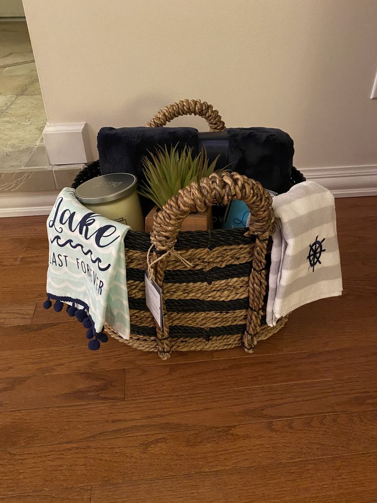 a basket with towels and other items sitting on the floor