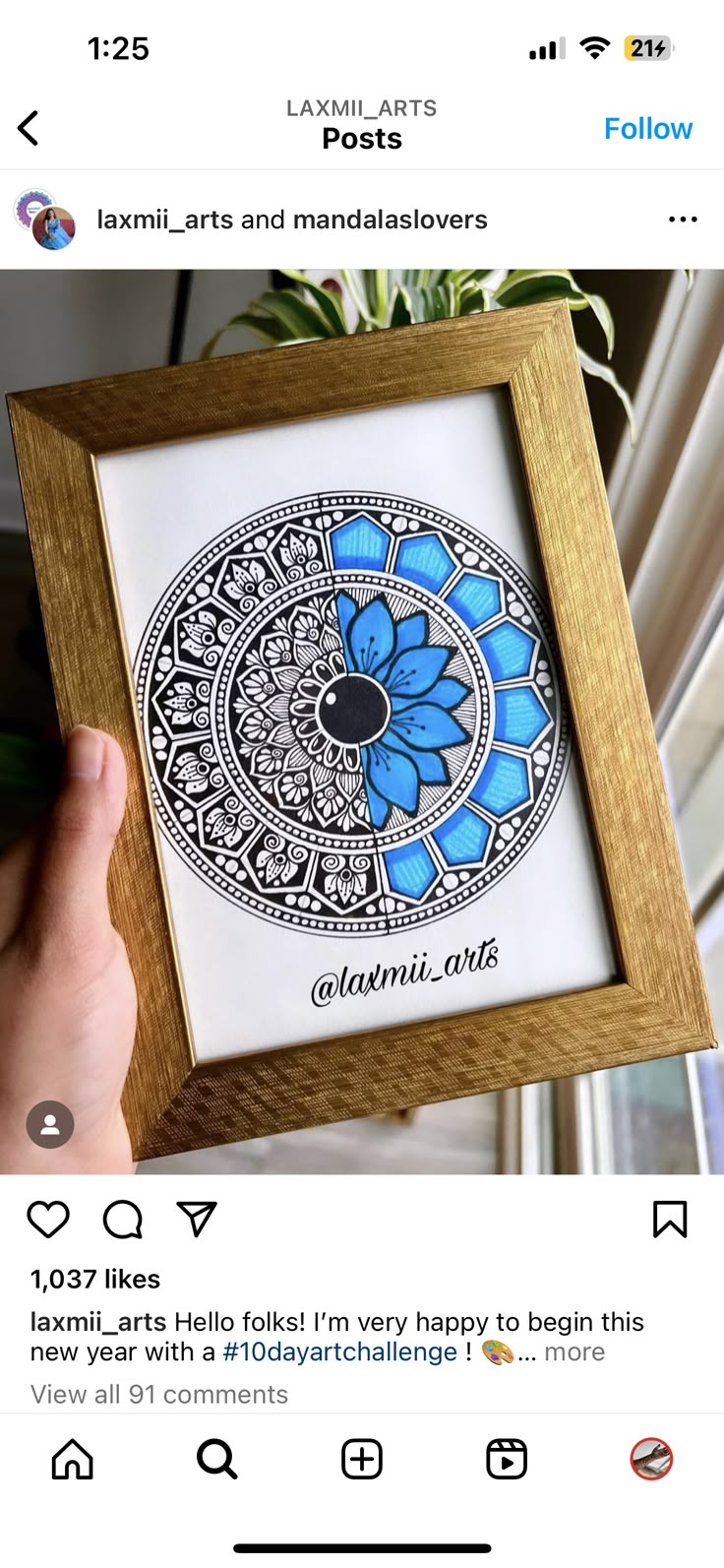 someone is holding up a framed artwork with blue flowers in the center and words below it