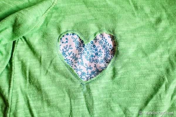 a green shirt with a heart on it