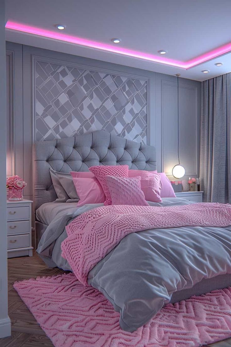 a pink and grey bedroom with a large bed