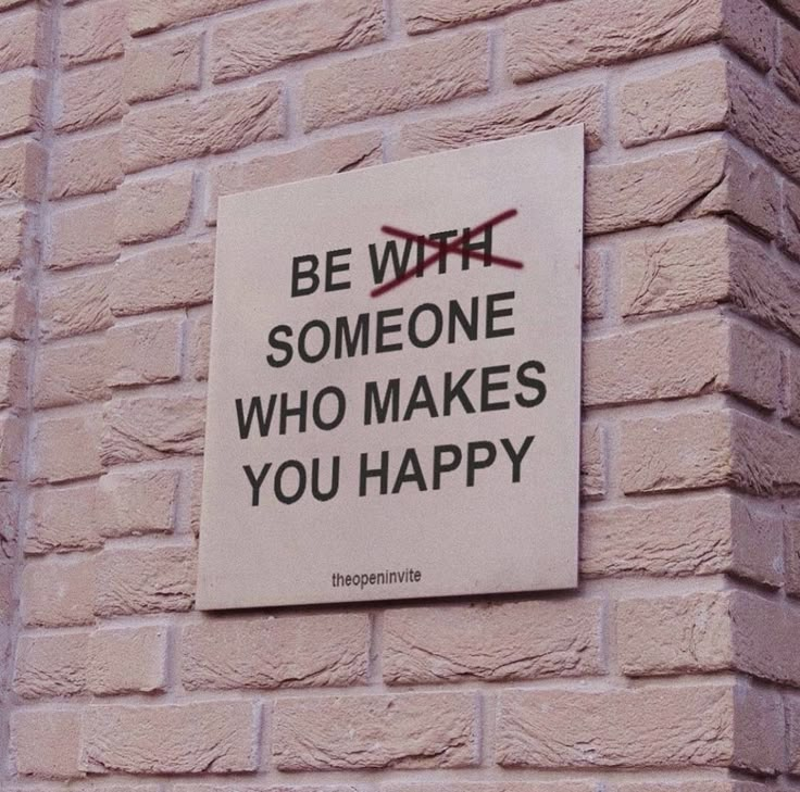 a sign on the side of a brick building that says be with someone who makes you happy