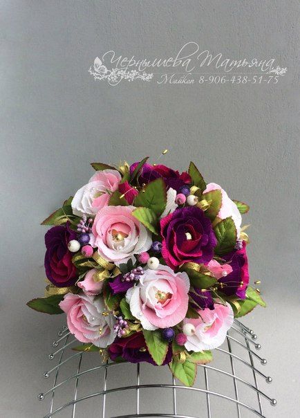 a bridal bouquet is sitting on a wire rack