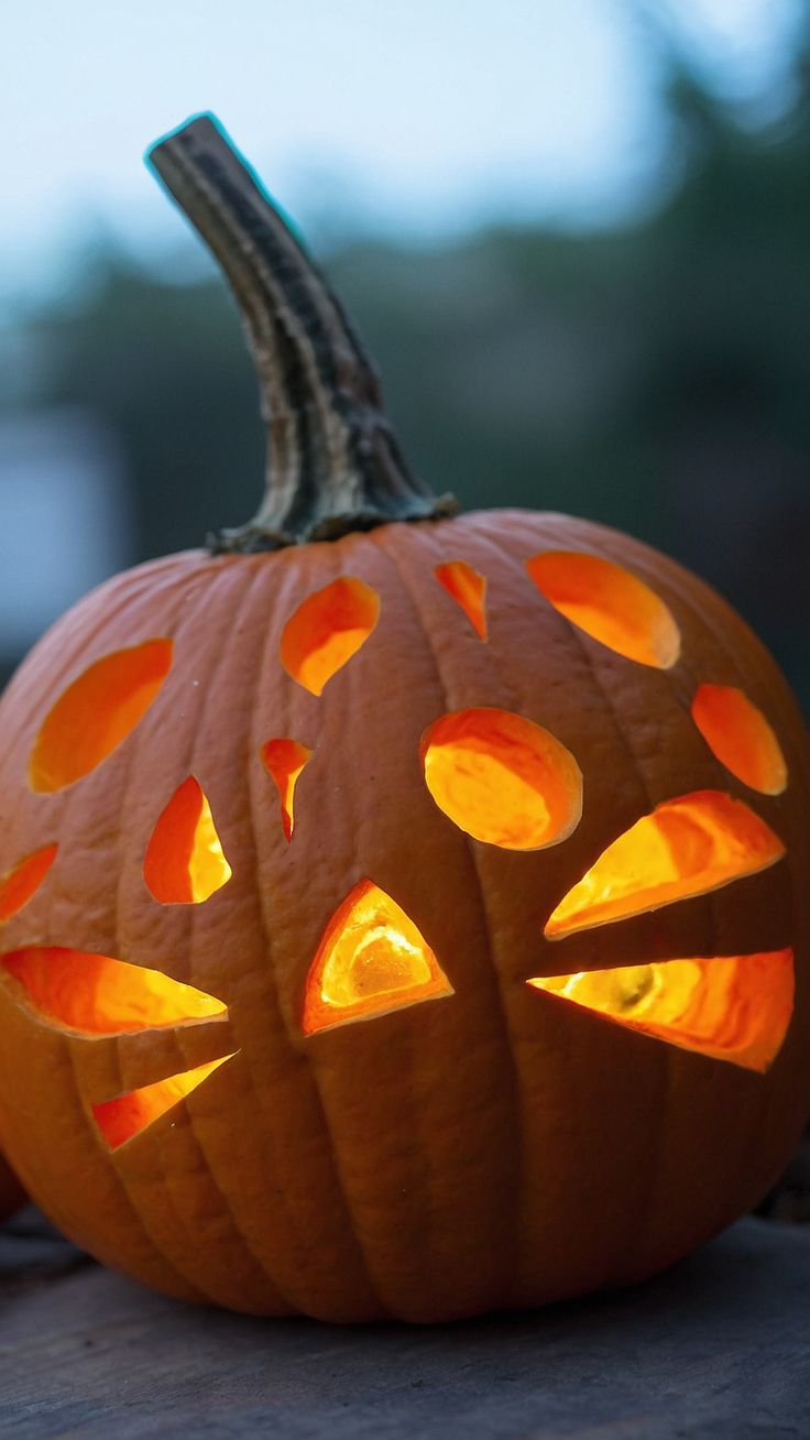 a carved pumpkin with glowing eyes on it