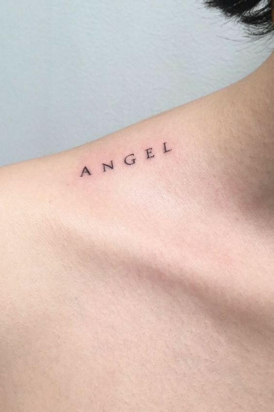 a woman's back with the word angel tattooed on it