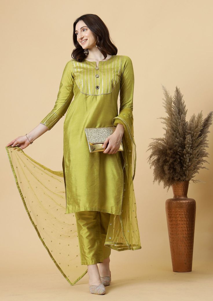 Our exquisitely crafted silk suits, designed for women who desire a blend of sophistication, luxury, and style. These stunning ensembles promise to elevate your evening wear, ensuring you shine with timeless elegance at any event. Details: Fabric: Cotton Silk Color: Lawn Green                                                                                                 Top Type: Straight Kurti Neck/ Neckline: Round Neck Top Pattern Detail: Gotta Work Sleeve Detail: 3/4th Sleeves Bottom Type: P Elegant Cotton Silk Traditional Wear With Gota Work, Elegant Traditional Wear With Gota Work In Cotton Silk, Elegant Slub Silk Sharara With Sheer Dupatta, Festive Silk Unstitched Suit, Elegant Cotton Silk Dress With Gota Work, Traditional Drape Silk Palazzo Set With Self Design, Elegant Green Slub Silk Anarkali Set, Elegant Green Art Silk Anarkali Set, Elegant Green Palazzo Set With Gota Work