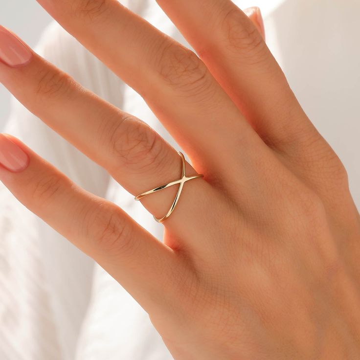 The Plain X Ring is made with a genuine design so that you could wear it with confidence in any environment you wish to be present. Its particular design will make you look more elegant than usual and induce all the eyes around you to stare at your minimalist beauty. - Made in 14k solid gold - Band Width: 1.07 mm / 0.04 inches - Ring Width: 8.00 mm / 0.31 inches - Thickness: 1.20 mm / 0.04 inches - This product comes with iconic Norm Jewels gift box Diamond Stackable Rings, Double Band Ring, Plain Gold Ring, Criss Cross Ring, Double Band Rings, Plain Rings, X Ring, Crossover Ring, Luxury Jewelry Brands