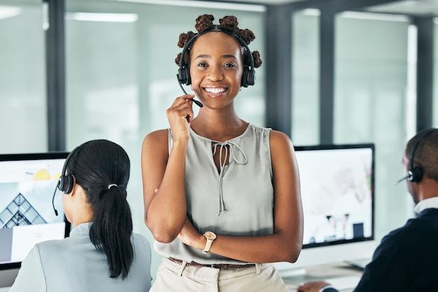 a woman talking on the phone while standing in front of two other people at desks