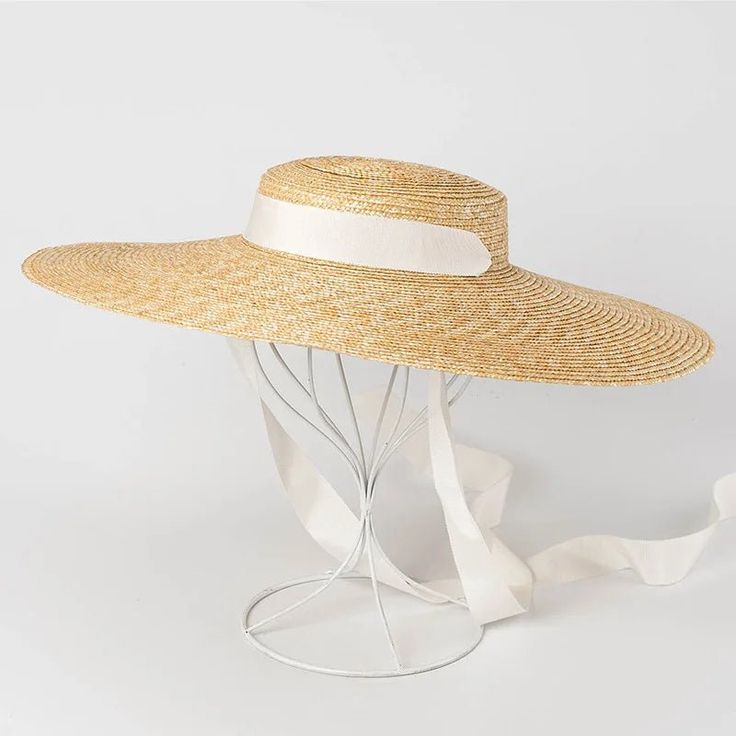 Complete your summer look with our Wide Brim Straw Boater Hat, a timeless accessory for sunny days. Crafted from straw, this boater hat features a wide brim that offers stylish sun protection. Perfect for beach outings or picnics, its classic design adds a touch of vintage charm to any outfit. Casual Straw Hat, Ethereal Classic, Old Money Summer, Beach Apparel, Straw Boater Hat, Shape Face, Straw Boater, Black And White Ribbon, Floppy Sun Hats