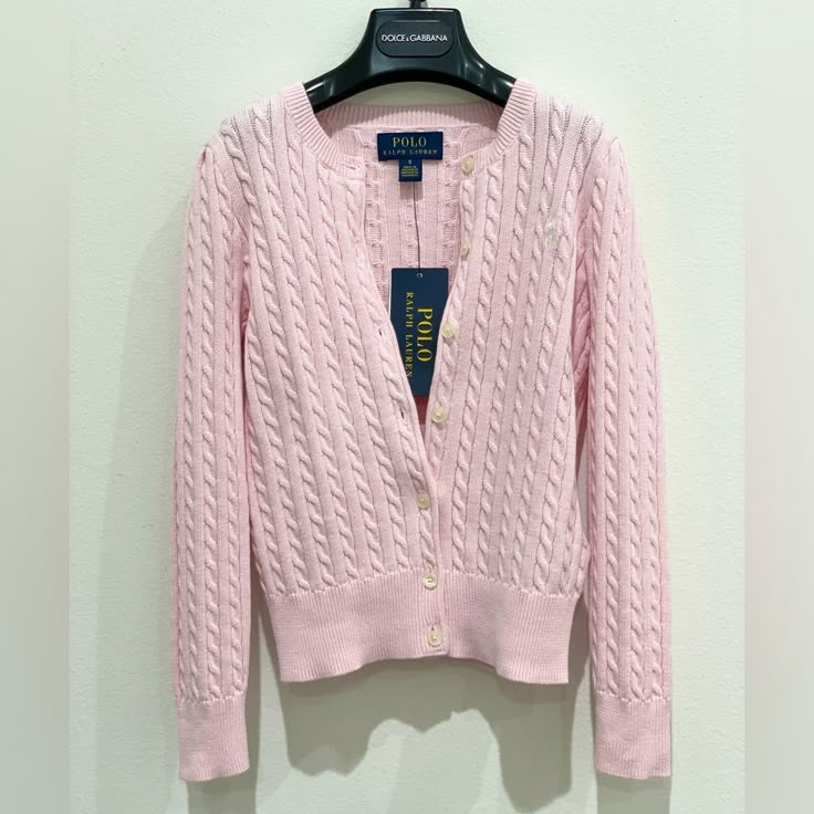 As Iconic As When It Was Introduced Decades Ago, Ralph Lauren's Classic Pink-Knit Cardigan Is A Layering Essential. This Version Features The Signature Embroidered Pony At The Left Chest For A Hint Of Heritage Style. Long Sleeves With Ribbed Cuffs. Ribbed Hem. Buttoned Placket. Imported Crewneck. Signature Embroidered Pony At The Left Chest. Material & Care Machine Washable All Cotton Classic Pink Knit Sweater, Fitted Ralph Lauren Classic Cardigan, Classic Fitted Ralph Lauren Cardigan, Classic Ralph Lauren Winter Cardigan, Classic Ralph Lauren Cardigan For Winter, Classic Pink Knit Top, Classic Pink Cable Knit Sweater, Casual Ralph Lauren Winter Cardigan, Ralph Lauren Classic Spring Sweater