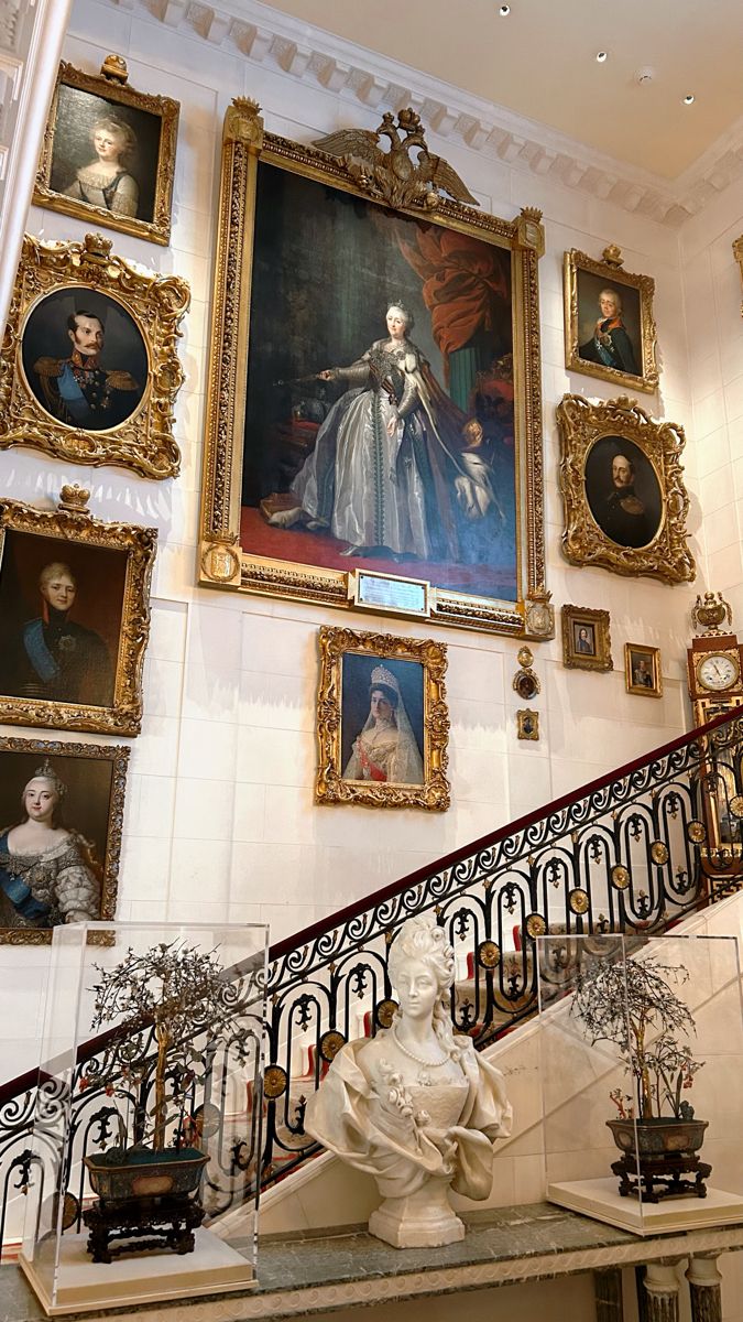 an ornate staircase with paintings on the wall