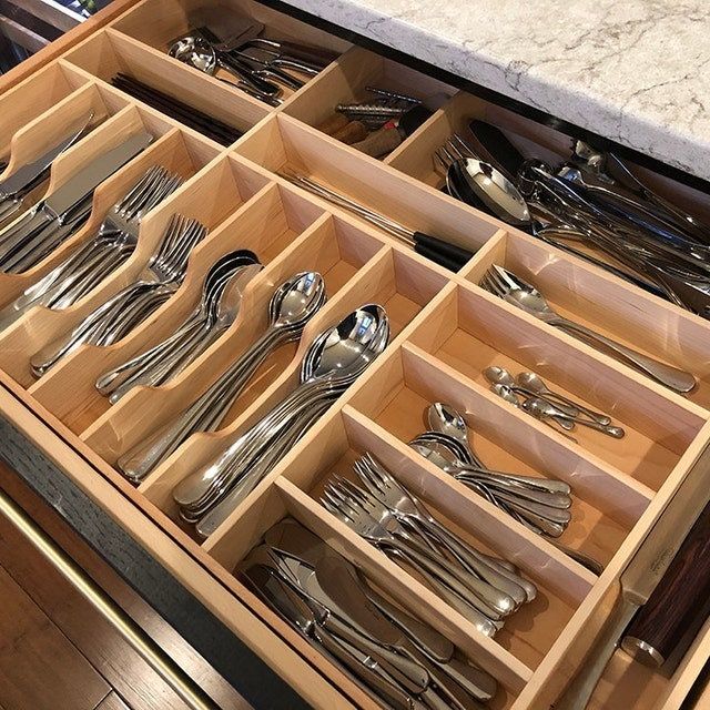 an open drawer with silverware in it