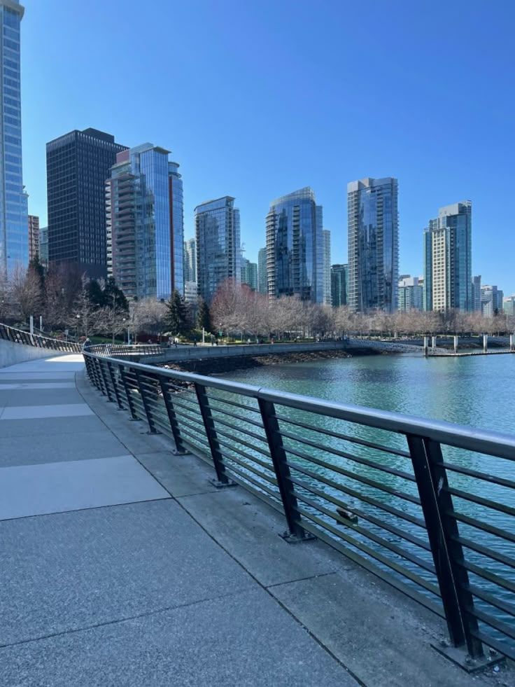 the city skyline is reflected in the water