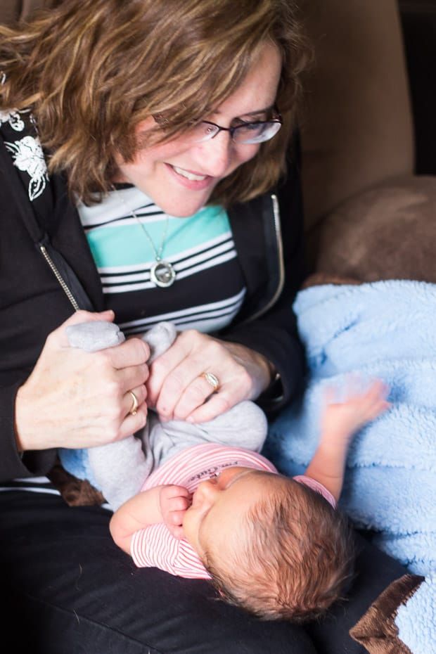 a woman holding a baby in her lap