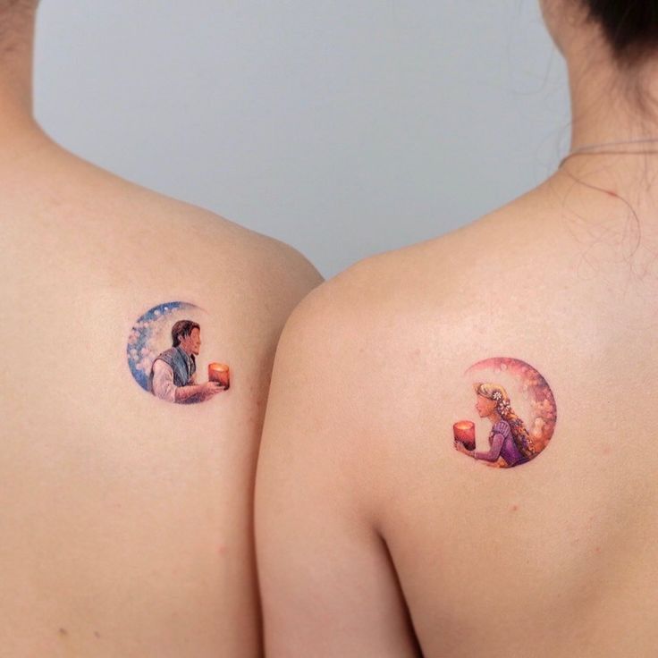 two women with small tattoos on their backs