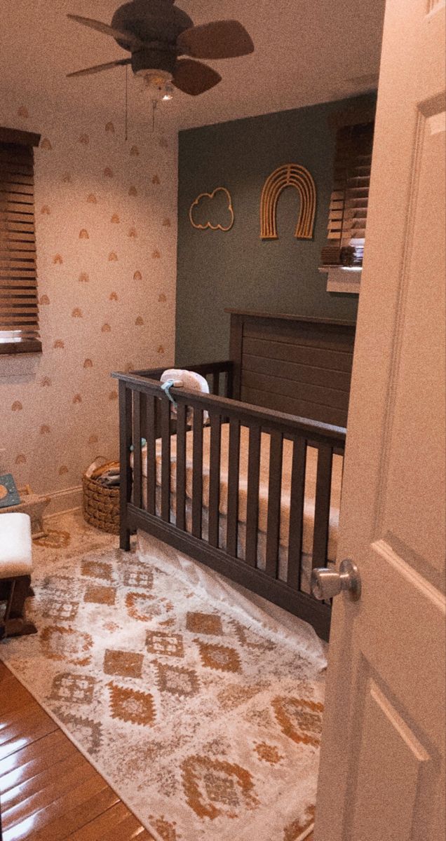 a baby's room with a crib and bed