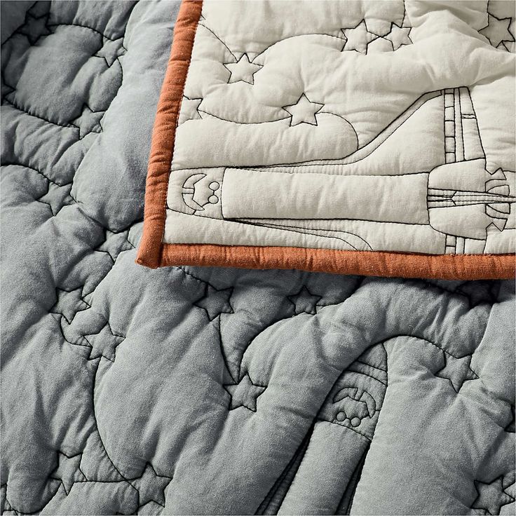 an airplane quilted on top of a bed