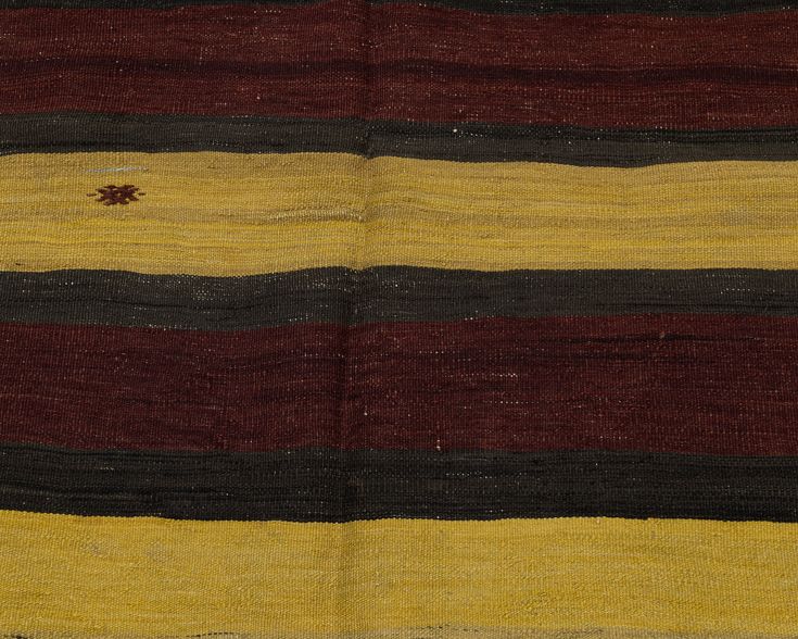 an old striped rug is shown with brown, yellow and black stripes on the bottom