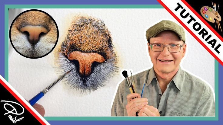 a man holding a paintbrush in front of a drawing of an animal's face