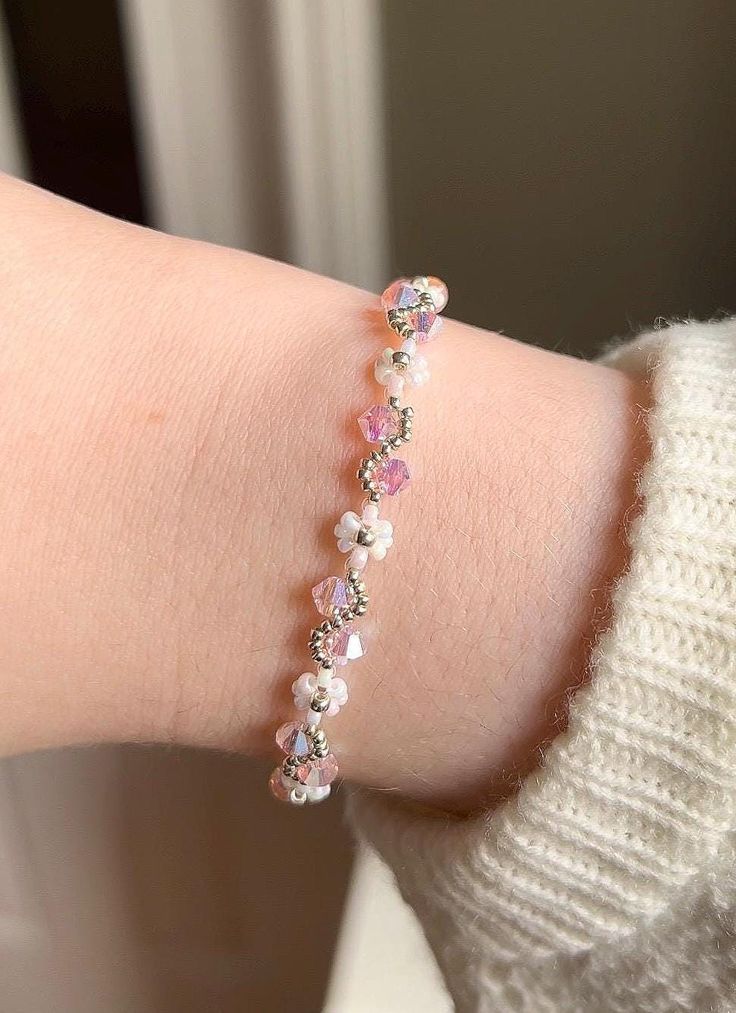 A beautiful handmade bracelet with an alternating flower and vine pattern, available in silver or gold and they come in a variety of colours. This bracelet makes the perfect gift for any occasion, and gives a magical vibe to any outfit! The crystals have a stunning iridescent effect, and can be seen in slightly different colours depending on the lighting and angle. They are all reflective so that they glisten and sparkle beautiful colours in the light to give a true magical feeling to the wearer Delicate Flower Shaped Crystal Bracelet As Gift, Delicate Flower Shaped Crystal Bracelet Gift, Dainty Flower Crystal Bracelet Gift, Adjustable Crystal Bracelet With Flower Charm, Adjustable Flower Crystal Bracelet Gift, Adjustable Delicate Beaded Bracelets With Flower Charm, Dainty Adjustable Flower Charm Bracelet, Flower Shaped Crystal Bracelet For Jewelry Making, Dainty Flower-shaped Crystal Bracelet