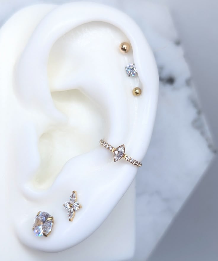 a pair of ear piercings sitting on top of a white object