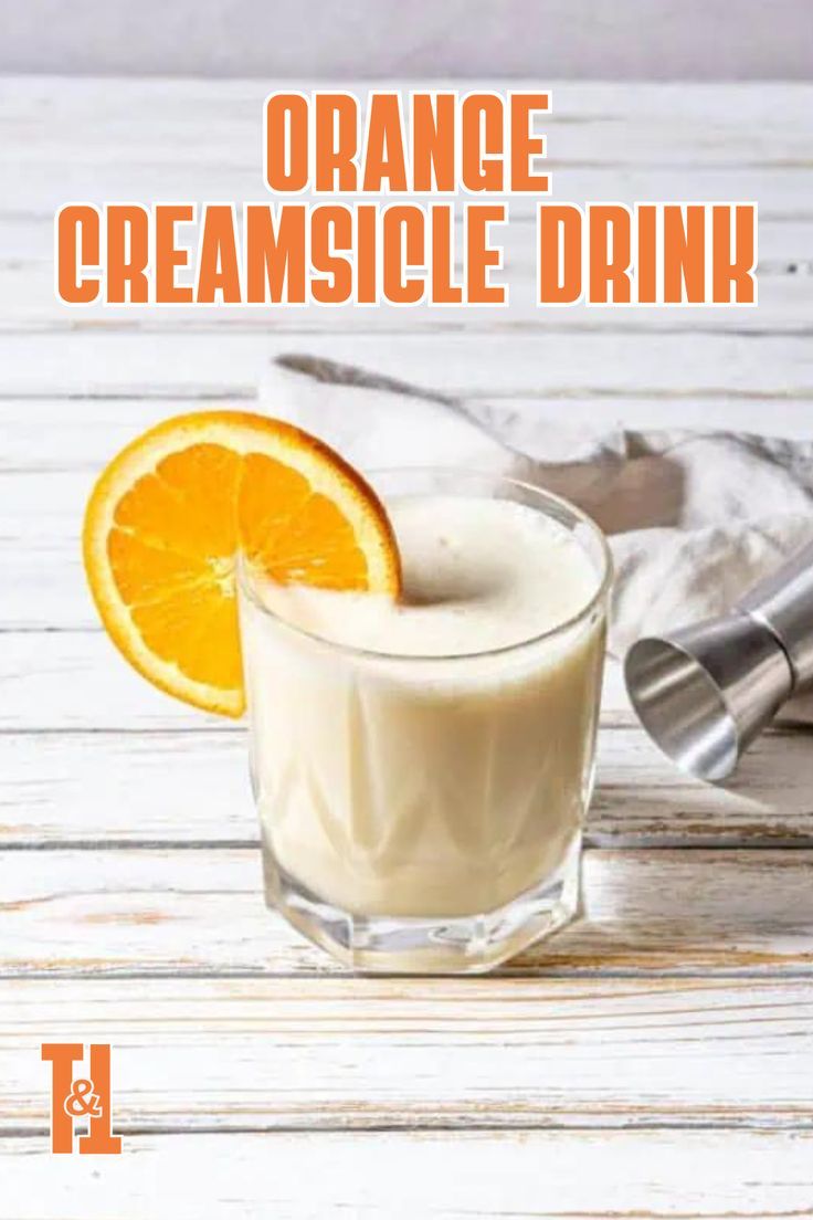 orange creamsice drink in a glass with an orange slice