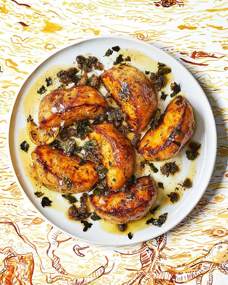 a white plate topped with grilled chicken on top of a yellow tablecloth covered table