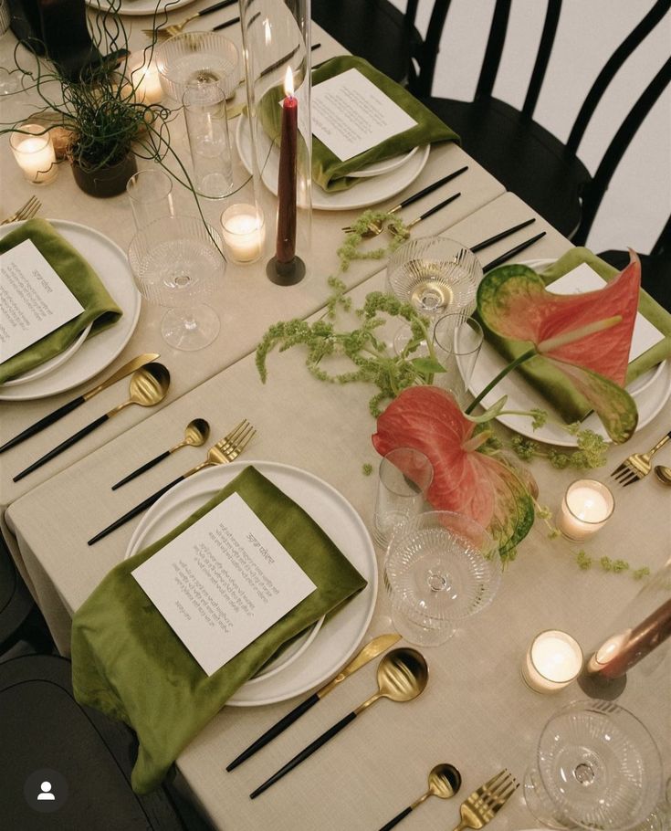 the table is set with place settings for dinner