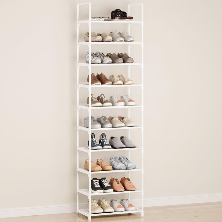 a white shelving unit with several pairs of shoes on the top and bottom shelves