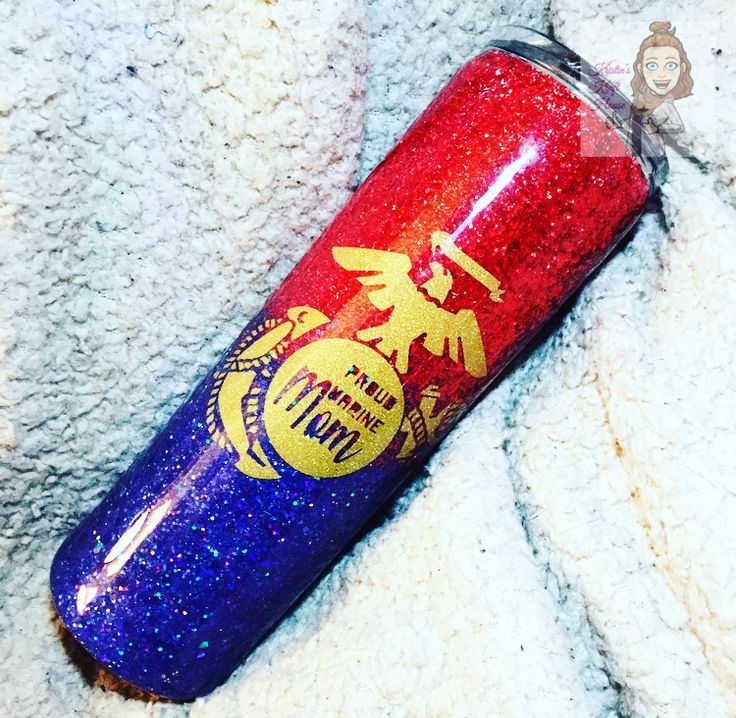 a red and blue tumbler sitting on top of a white blanket next to a stuffed animal