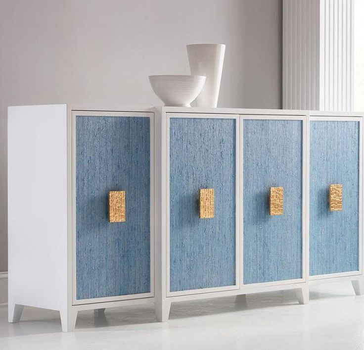 a blue cabinet with two doors and some gold magnets on the door knobs