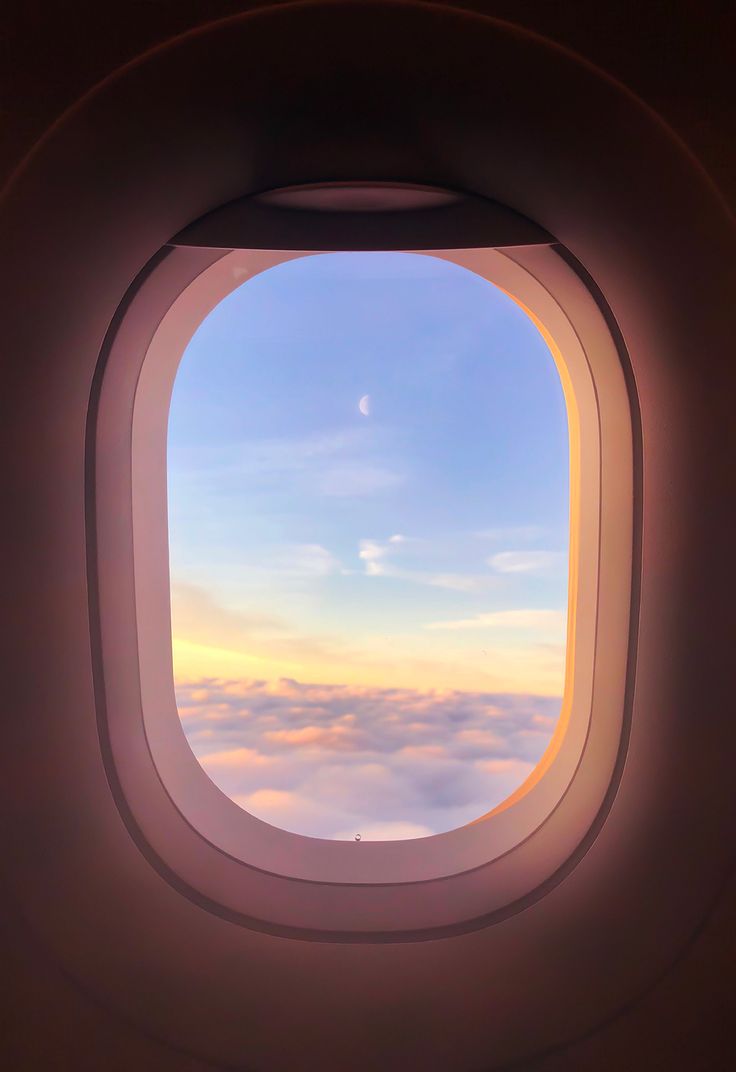 an airplane window looking out at the clouds