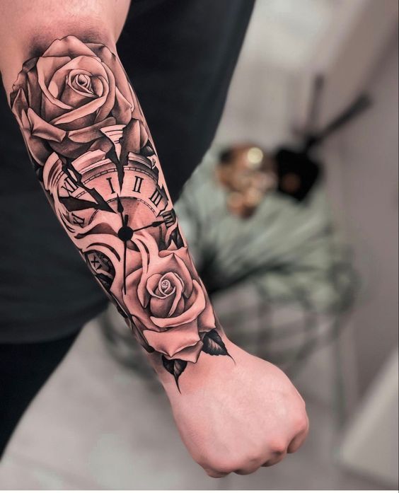 a person with a tattoo on their arm holding a clock and roses in the background