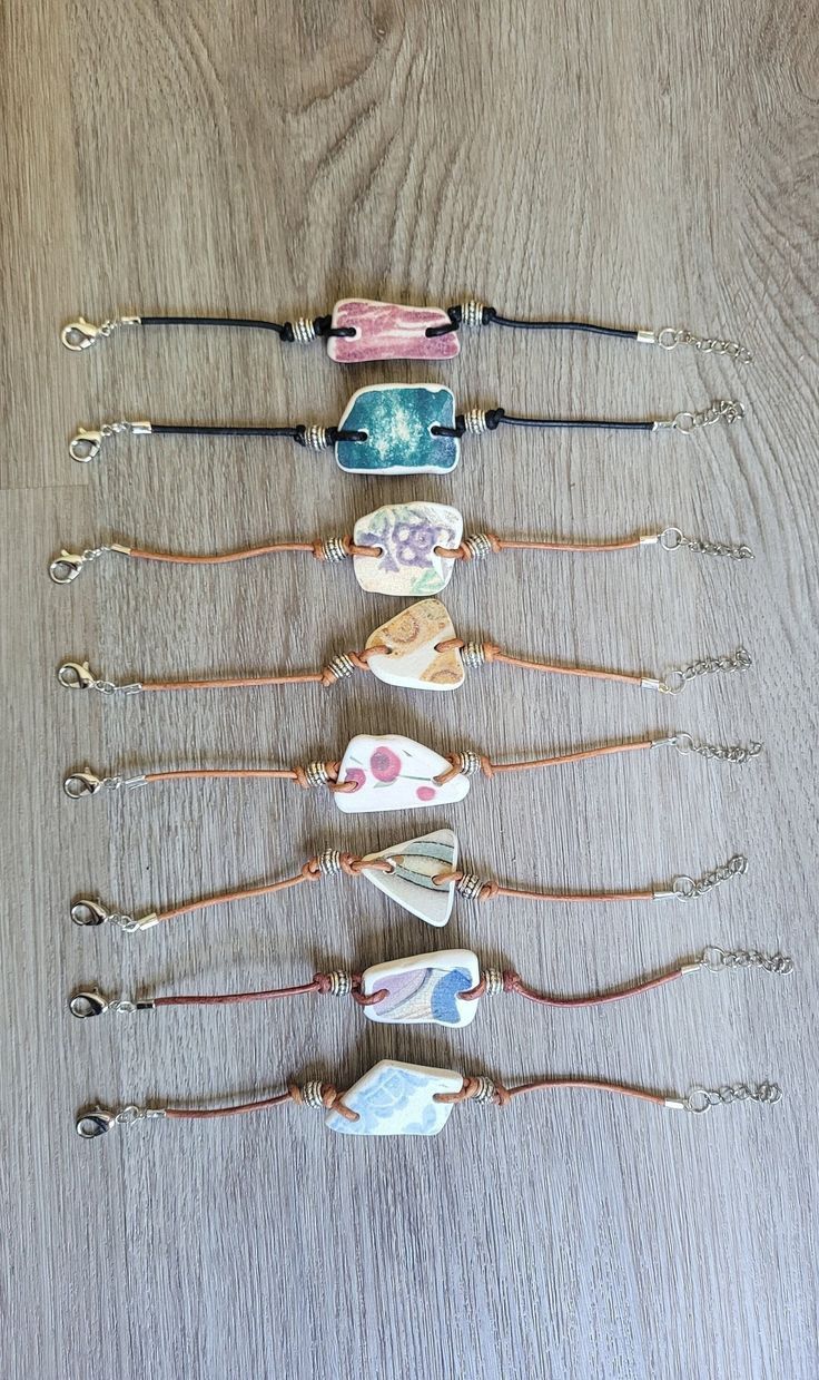 five different bracelets are lined up on a table