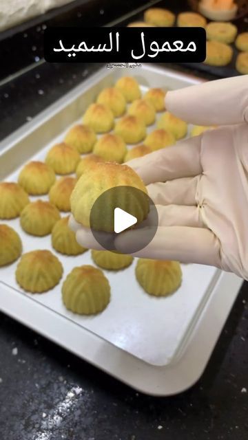 a person in white gloves is making pastries on a baking sheet with the words, learn arabic