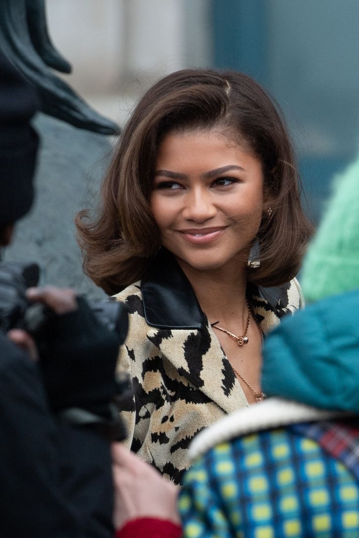 a woman is smiling and talking to someone