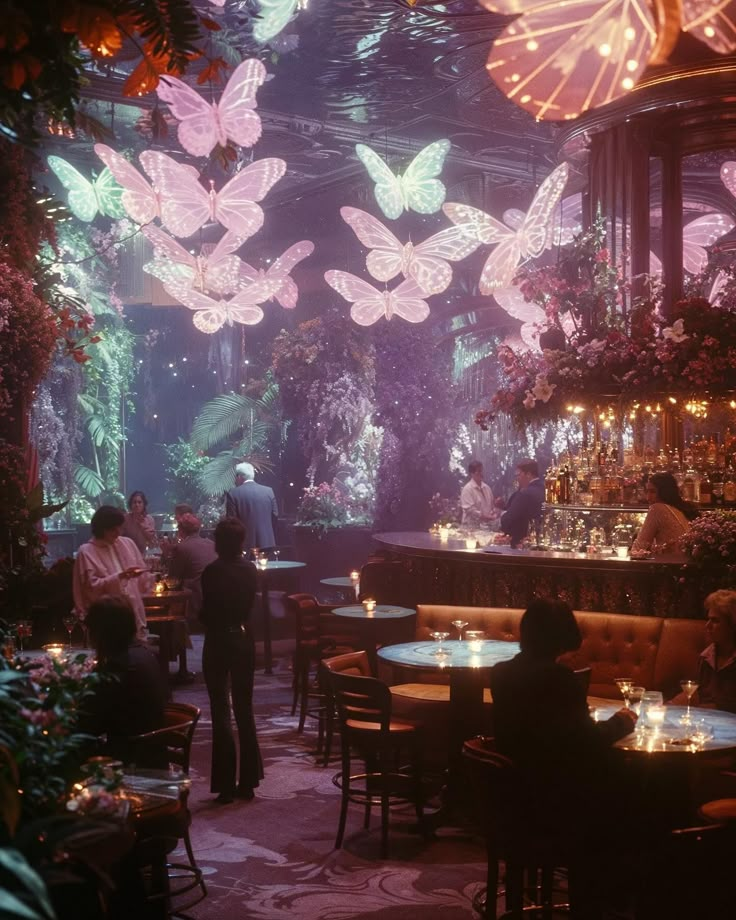 people sitting at tables in a restaurant with butterflies hanging from the ceiling