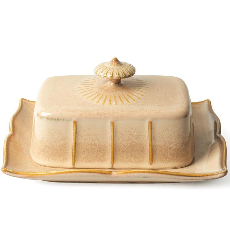 a white and gold platter with a lid