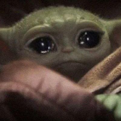 a baby yoda is peeking out from behind a blanket