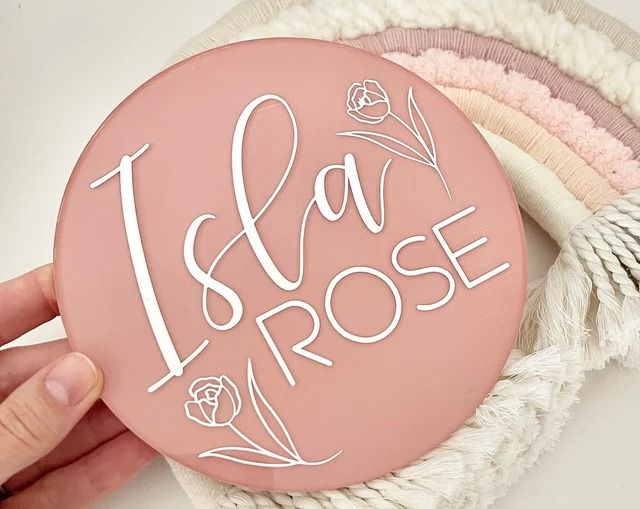 a pink button with the words i am rose written on it in white letters and flowers