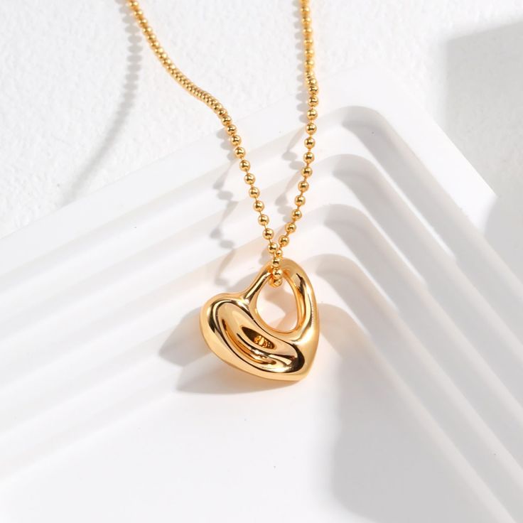 Embrace the timeless elegance of this beautiful heart-shaped pendant necklace, crafted from premium 925 sterling silver and finished with a lustrous 14k gold plating.  The centerpiece of this stunning piece is a sleek, modern heart-shaped pendant, measuring approximately 17mm in size. The simple yet striking design allows the natural shine and beauty of the gold plated sterling silver to take center stage, creating a refined, minimalist look. Whether you're dressing up for a special occasion or Elegant Heart-shaped Necklace As A Gift For Her, Timeless Polished Jewelry For Valentine's Day, Luxury Sterling Silver Heart Pendant Necklace, Classic Tarnish Resistant Heart Pendant Necklace, Classic Tarnish-resistant Heart Pendant Necklace, Elegant Heart Necklace For Mother's Day, Elegant Open Heart Necklace For Mother's Day, Elegant Gold Double Heart Jewelry, Heart Pendant Necklaces For Mother's Day