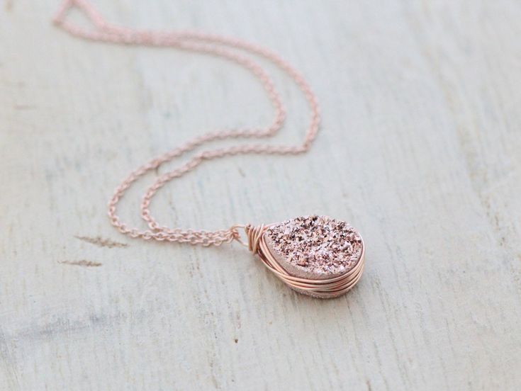 A high quality, genuine Druzy Quartz teardrop gilded in a rose gold titanium finish, is generously secured in my signature bezel wrapped style in 14k rose gold filled wire and suspended from delicate yet very sturdy 14k rose gold filled chain that I've hand finished for added durability. This necklace is a gorgeous piece that wears well alone or layered with other pieces. It would look fantastic with a hand stamped piece like this: https://www.etsy.com/listing/151477068/gold-bar-necklace-persona Rose Gold Wire Wrapped Necklace, Rose Gold Copper Jewelry For Anniversary, Anniversary Rose Gold Copper Jewelry, Anniversary Rose Gold Wire Wrapped Jewelry, Rose Gold Copper Round Necklace, Rose Gold Copper Round Necklaces, Rose Gold Round Necklaces, Geode Jewelry, Druzy Jewelry