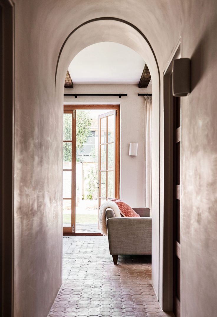 an archway leading into a living room with a couch