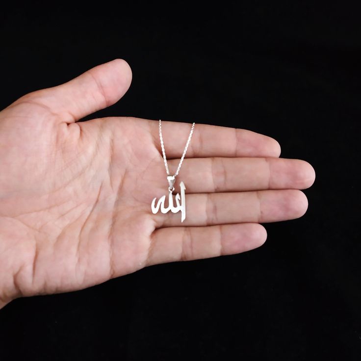 Title: Allah necklace - Islamic necklace - Sterling silver jewelry - Muslim necklace - Arabic necklace - Arabic name necklace - 925 sterling silver and 14k solid gold options are available. - For 14k solid gold necklace, the total weight of the necklace can be between 2 and 3.5 grams. - If you have your own idea and want a special design please let us know we can design it for you. - To protect the necklace from fading and tarnishing keep it away from chemical materials, deodorant, perfume, soap