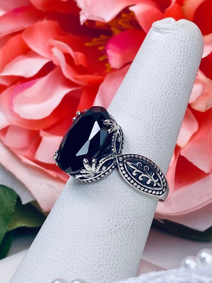 5ct. Black Onyx Cubic Zirconia (CZ) Solid Sterling Silver RingDragon Design#D133 This lovely sterling silver filigree ring is set with a stunning 5ct. Black Onyx Cubic Zirconia (CZ) gemstone solitaire. This oval cut gem is 14mm by 10mm. The ring sits 8mm off the finger. The inside of the band is marked 925 for solid sterling silver. Notice the detailed design of the silver filigree setting and band. This is an exquisite rendition of a Gothic ring. The Renaissance filigree has amazing elegance. Gothic Ring, Nature Ring, Gothic Rings, Black Onyx Ring, Sterling Silver Filigree, Onyx Gemstone, Detailed Design, Cubic Zirconia Rings, Dragon Design