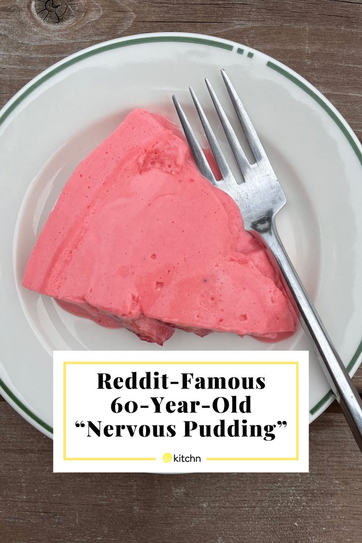 a white plate topped with a piece of cake next to a fork on top of a wooden table