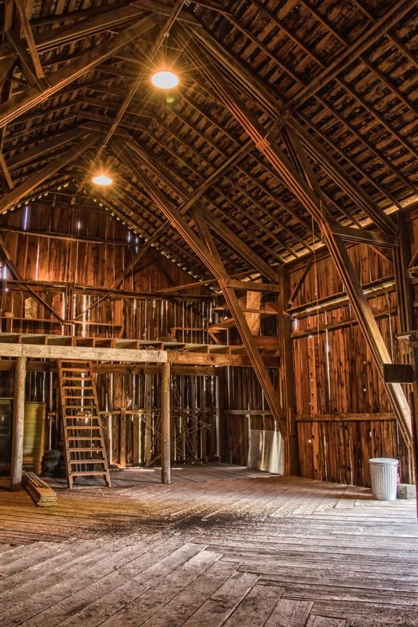 the inside of an old barn with wooden floors