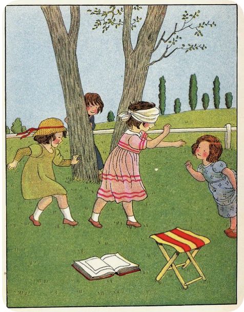 children are playing in the grass with an open book