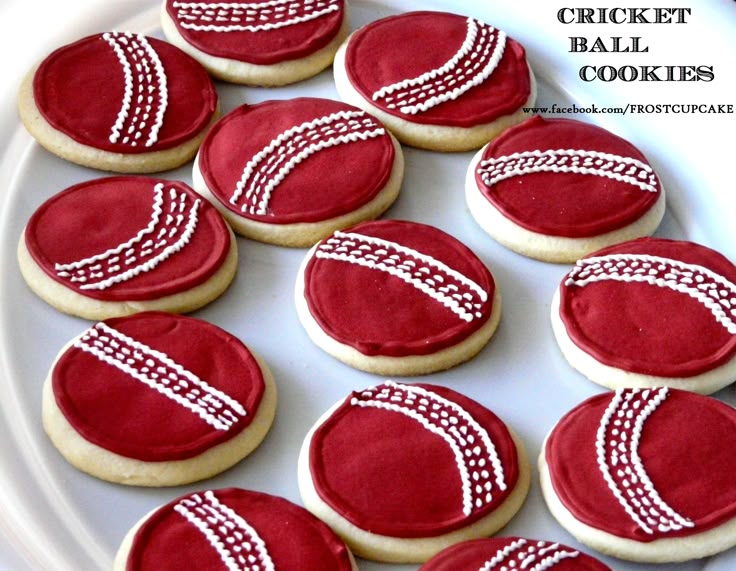 red and white decorated cookies on a plate with the words cricket cookies written across them